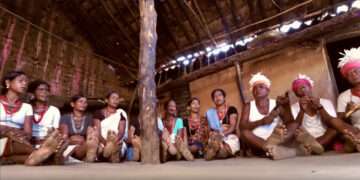Nuapada tribals in traditional dresses and headgear adorned with feathers sing and play musical instruments to celebrate a Saora marriage | The Indian Tribal
