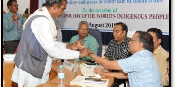 A Tribal Healer (Gunia) Performing Naadi Parikshan Of A Medical Scientist