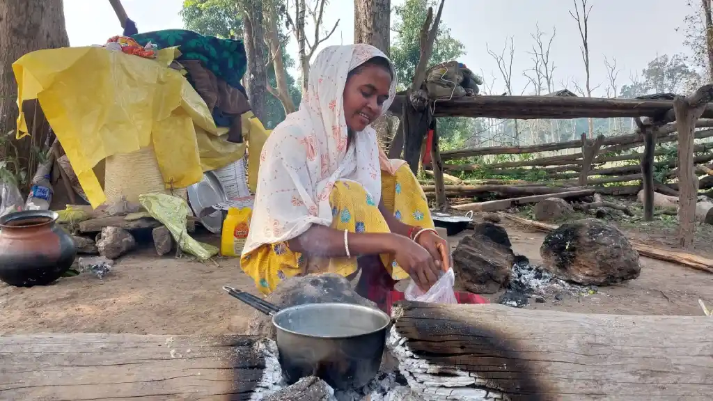 Woman prepares tea using tree logs for firewood I The Indian Tribal