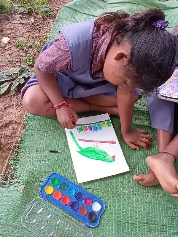 The Indian Tribal | A child immersed in drawing her imagination